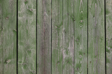 Green Painted Wooden Peeling Off Fence. Rough Texture Background.