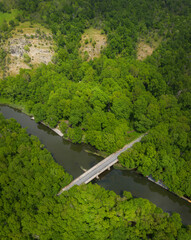 Aerial view to a bridge over the river in the mountain