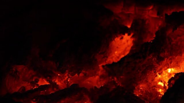 Rescoldos rojos y llamas amarilla en fuego de chimenea