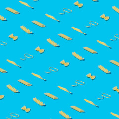 Mixed pasta on a pastel blue background as a pattern. Minimal food concept.