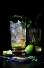 Two mojitos on a black background