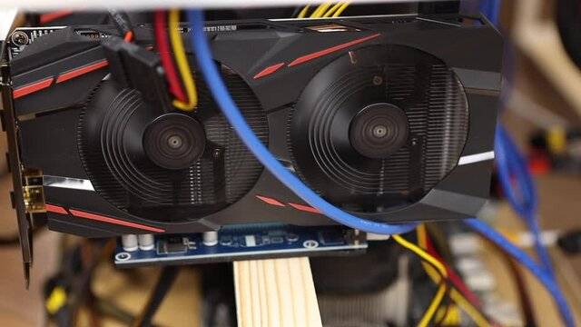 Cryptocurrency mining farm, extraction of bitcoins, ethereum. Fans spinning on video cards, close-up, macro. Selective soft focus. Digital money concept, e-commerce, alternative currency, blockchain