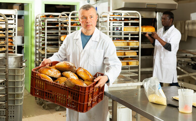Baker sorts finished products at the bakery. High quality photo