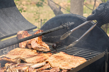 cooking on a charcoal and wood barbecue