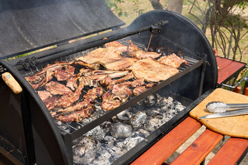 cooking on a charcoal and wood barbecue