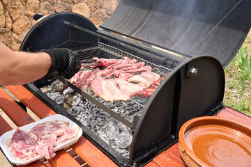 cooking on a charcoal and wood barbecue
