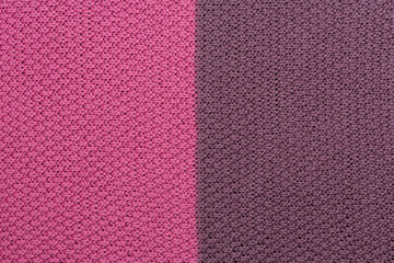 Pink and brown knitted fabric pearl woolen background. The structure of the fabric with a natural texture. Fabric background. Knitted woolen background.