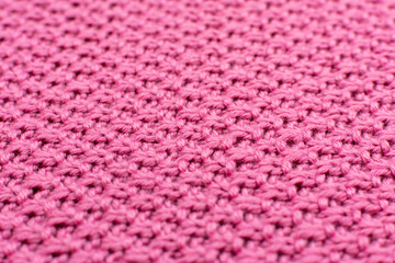 Knitted fabric pearl woolen background, close-up. The structure of the fabric with a natural texture. Fabric background. Knitted woolen background. Close-up.