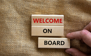 Welcome on board symbol. Wooden blocks with words 'Welcome on board'. Beautiful canvas background, businessman hand. Business, welcome on board concept, copy space.