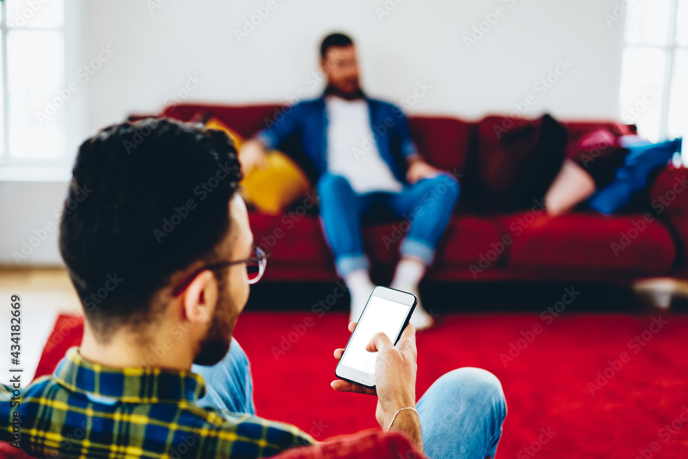 Aufkleber back view of millennial blogger connecting to 4g wireless on mockup smartphone technology for browsi