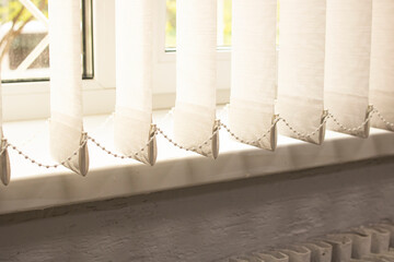 White blinds and window sill in sunlight