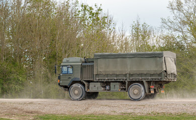 British army MAN SV 4x4 army lorry logistics vehicle truck driving along a dirt track on maneuvers, Salisbury Plain Wiltshire