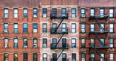 Old brick apartment buildings with windows and fire escapes along Second Avenue in the Upper West...