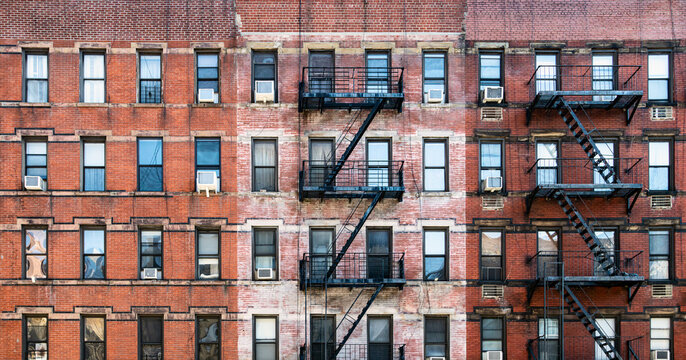 Old brick apartment buildings with windows and fire escapes along Second Avenue in the Upper West Side of Manhattan, New York City NYC