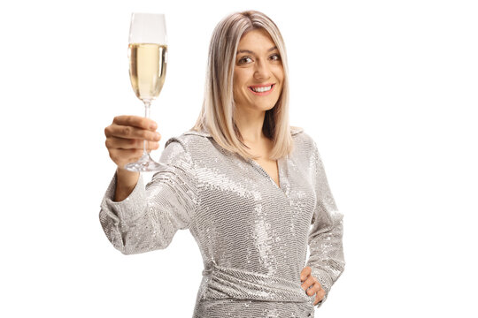 Elegant young woman in a dress toasting with a glass of sparkling wine