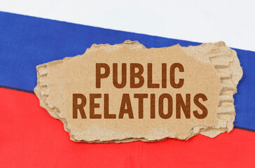 Against the background of the Russian flag lies cardboard with the inscription - Public Relations
