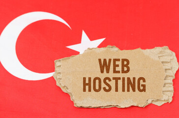 Against the background of the flag of Turkey lies cardboard with the inscription - Web Hosting