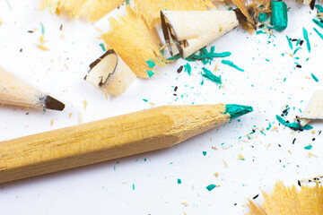 Shavings and a broken pencil.  Graphite on white background. Close up, Macro photo.