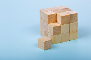 Wood Cube Block Construction on blue Background