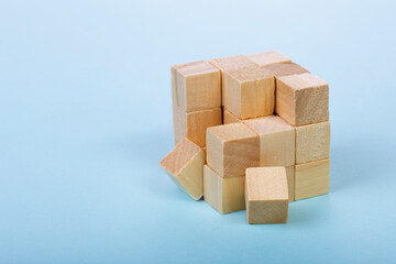 Wood Cube Block Construction on blue Background