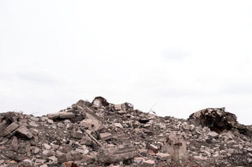 A pile of construction debris against a gray sky. Background