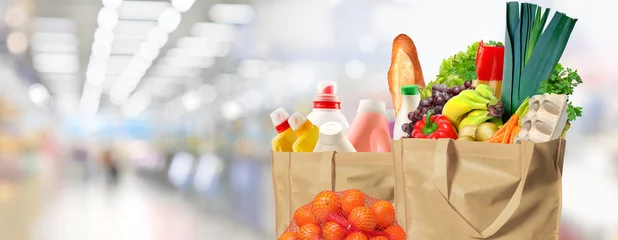 Foto op Plexiglas Eco friendly reusable shopping bags filled with different goods on a supermarket background © hacohob