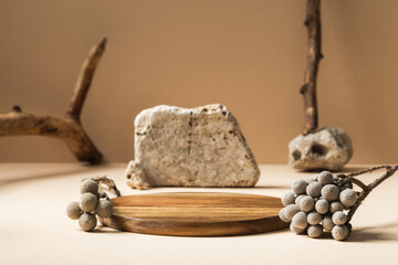 Wooden pad and stones, branches decorations around. Background for products cosmetics, food or...
