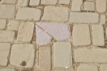 Paving stones from flat faceted stones. Background, texture, design. Close-up of stones.