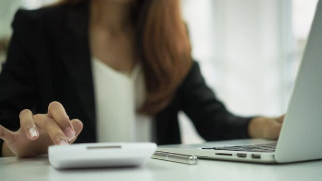 slow motion accounting  woman hand pressing on calculator for calculate about monthly profit of business  for senior accountant job working concept	