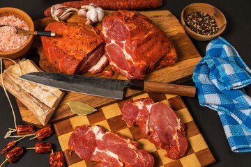 Meat, Pork neck in marinade and on a chopping boardon. Raw steak meat pork neck on chopping board with chili. Raw meat for grilling. Black background.