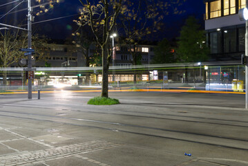 Obraz premium Tram station Schwamendingerplatz (Schwamendingen square) at City of Zurich by night. Photo taken May 17th, 2021, Zurich, Switzerland.