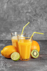 Freshly squeezed orange juice and banana and orange smoothies in tall glasses