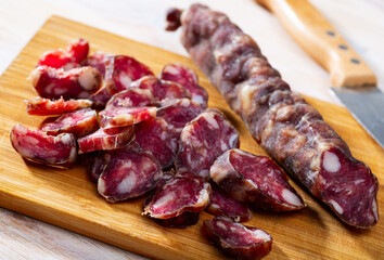 Traditional French dried sausage on cutting board. High quality photo