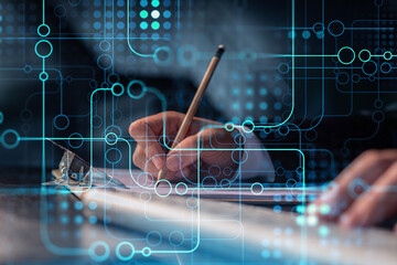 Hands writing down some ideas to create innovative software to change the world and provide a completely new service. Close up shot. Hologram tech graphs. Concept of Dev team. Formal wear.