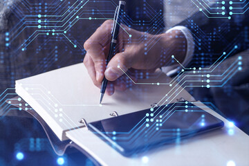 Arm in formal wear writing down some ideas using phone to create innovative software to provide a...