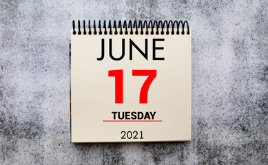 June 17th. Day 17 of june month, calendar on table with blue background. Summer time, empty space for text or template.