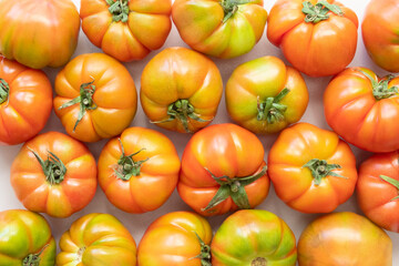 Fresh tomato, orange and green color, close-up