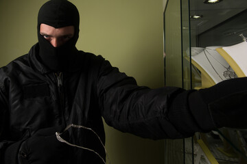 Fototapeta na wymiar Man Wearing a Mask Robbed a Jewelry Store