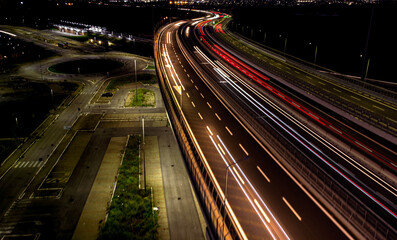 Fototapeta na wymiar traffic on highway at night drone view