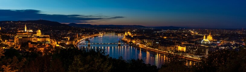 Night Budapest, Parliament against the background of the night city, reflection of lights in the river, panorama of the city