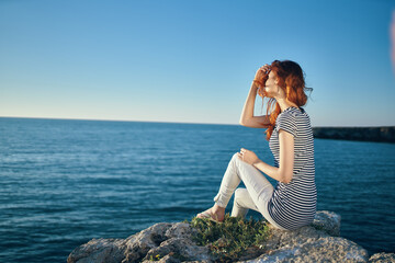 happy traveler on the beach near the sea in the mountains in summer and clear water