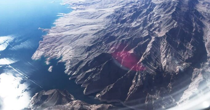 View of lake and mountains from airplane window 4K