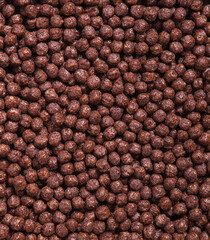 Wholegrain chocolate cereal balls wallpaper for healthy food store. Brown texture background. Nutritional breakfast
