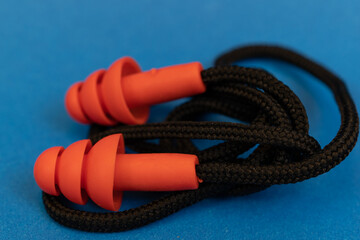 Silicone ear plugs for human ears on blue background