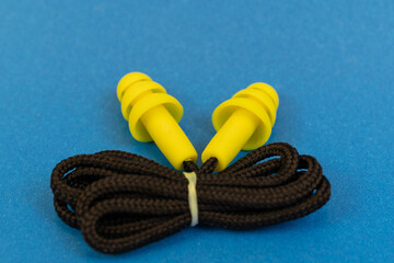 Silicone ear plugs for human ears on blue background