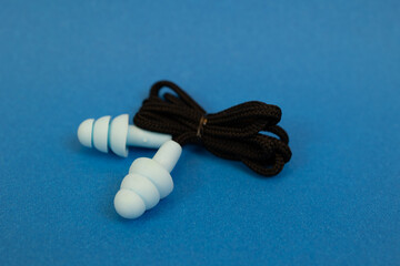 Silicone ear plugs for human ears on blue background