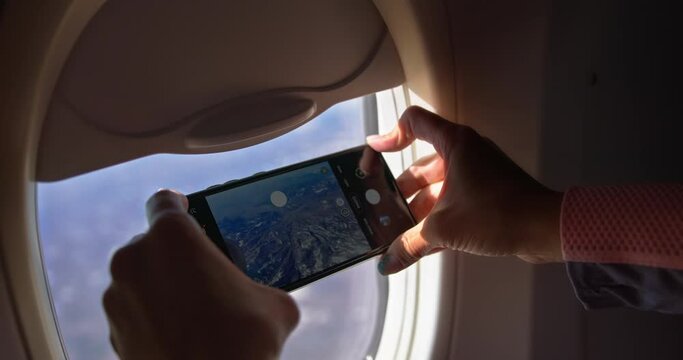 Young woman taking Pictures trough plane window Series 4K