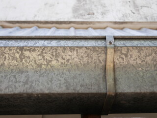 Obraz premium closeup of stainless steel rain gutter on the roof.