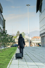 Walking away from the company with her traveling bag