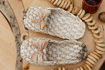 Straw shoes. Salted sandals. Vintage accessory. Ethnic footwear. Slavic culture background.